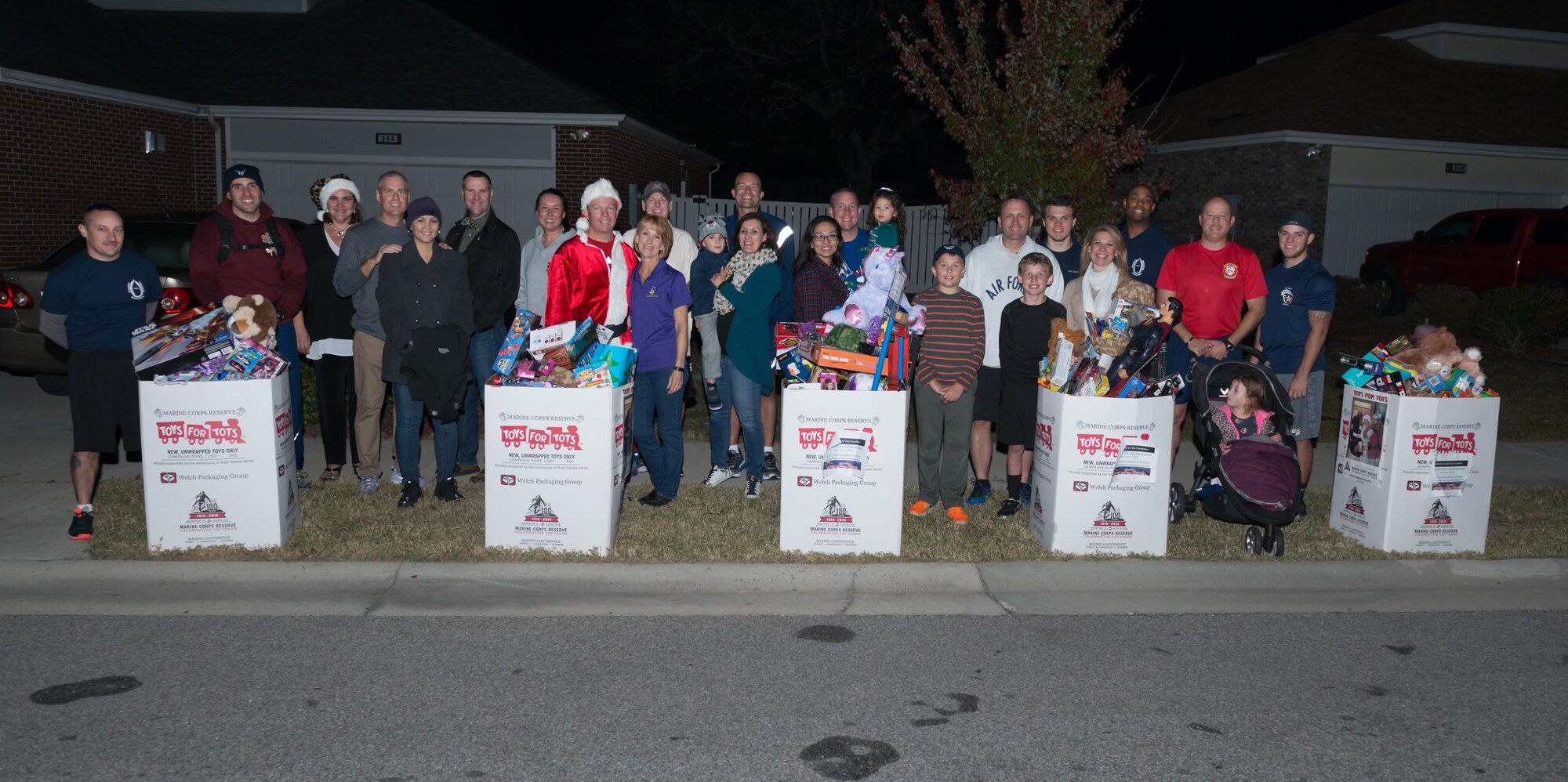 Family members and 81st Training Group leadership  pose for a photo with toy donations after a 5K “Toys for Tots” run, Dec. 11, 2016, on Keesler Air Force Base, Miss. The 5K run supported the U.S. Marine Corps Reserve Toys for Tots Program, which collects and distributes toys in the community.  (U.S. Air Force Photo by Andre’ Askew)