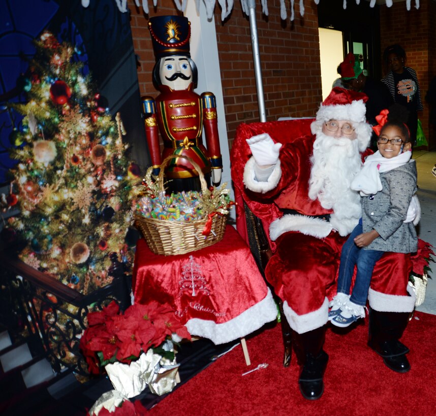 Santa Claus poses with a young child at Marine Corps Logistics Base Albany’s Christmas Tree Lighting Ceremony, Dec. 9.