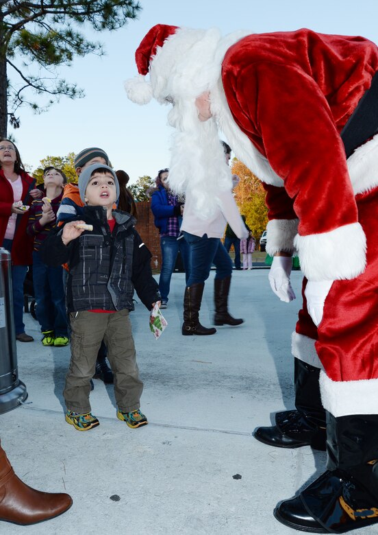 A young boy meets Santa Claus and tells him his Christmas list at Marine Corps Logistics Base Albany’s Christmas Tree Lighting Ceremony, Dec. 9.