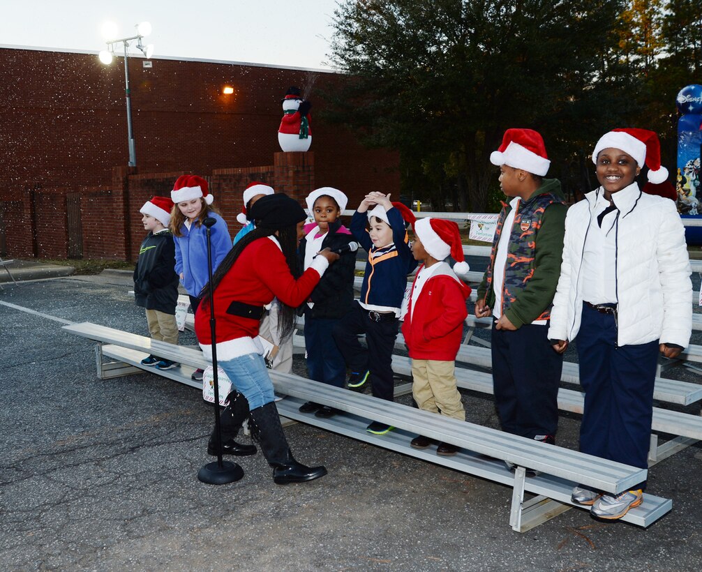Children from Marine Corps Logistics Base Albany’s Child Development Center sing Christmas songs during a Christmas Tree Lighting Ceremony at Marine Corps Logistics Base Albany, Dec. 9.