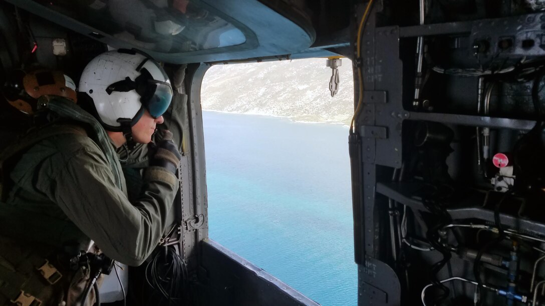 24th Marine Expeditionary Unit, Republic of Haiti--
A Marine CH-53 Super Stallion crewman with VMM-365, 24th Marine Expeditionary Unit communicates with the aircraft’s pilot during a survey mission of potential beach landing sites and airfields for upcoming humanitarian and disaster relief operations to assist the Republic of Haiti following Hurricane Matthew, a Category IV storm that passed through the area causing flooding, destroying vital infrastructure within the country and displacing Haitian local nationals.  A helicopter crew chief continuously inspects the aircraft and surrounding area for safety concerns and ensures all passengers and gear are transported safely during flight operations.