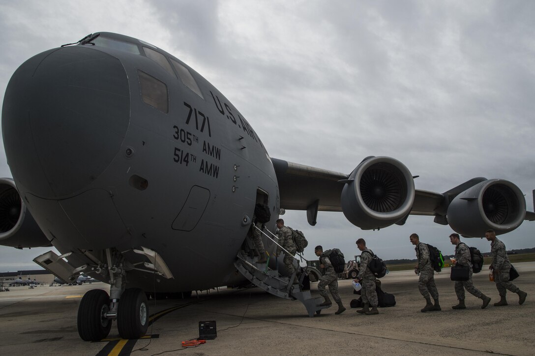 More than 30 members of the 621st Contingency Response Wing board a C-17 Globemaster III at Joint Base McGuire-Dix-Lakehurst, N.J., October 8, 2016. The Airmen are on their way to Port-au-Prince, Haiti, responding to Hurricane Matthew. The CRW has a history of supporting humanitarian aid and disaster relief operations, including the earthquake in Haiti in 2010 when its Airmen supported more than 150 flights per day, coordinating the delivery of 3.5 million tons of relief cargo. (U.S. Air Force photo by Tech. Sgt. Gustavo Gonzalez/Released)