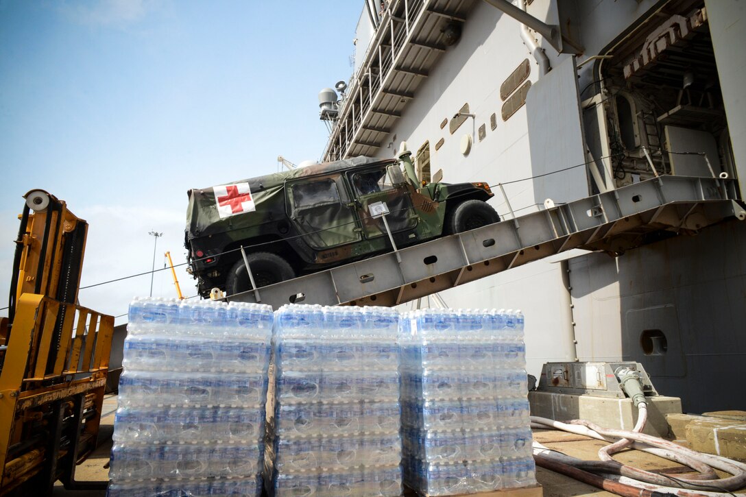 NORFOLK (Oct. 7, 2016) A medical vehicle attached to the 24th Marine Expeditionary Unit (24th MEU), drives aboard the  amphibious assault ship USS Iwo Jima (LHD 7) during an onload of more than 500 Marines from the 24th Marine Expeditionary Unit and nearly 300 pallets of supplies. Iwo Jima is moored pierside at Naval Station Norfolk awaiting further tasking as Hurricane Matthew develops. (U.S. Navy photo by Petty Officer 3rd Class Jess E. Toner/Released)
