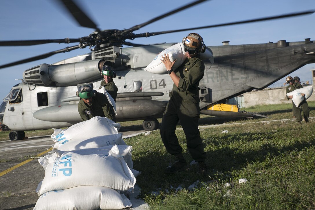 U.S. Marines with Special Purpose Marine Air-Ground Task Force Southern Command, deployed in support of Joint Task Force Matthew, offload bags of rice from a CH-53E Super Stallion at Les Cayes, Haiti, Oct. 6, 2016. JTF Matthew delivered over 10,000 pounds of supplies on their first day of relief operations, providing humanitarian and disaster relief assistance in the aftermath of Hurricane Matthew. (U.S. Marine Corps photo by Cpl. Kimberly Aguirre/Released)