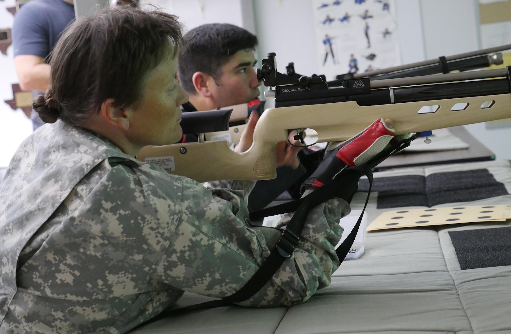 U.S. Army Staff Sgt. Tiffany Rodriguez-Rexroad, Bravo Company, Warrior Transition Battalion, Brooke Army Medical Center, inspects her air rifle before firing during a training session at Central Catholic High School, San Antonio, Texas, Nov. 10, 2016. The training is part of the WTB’s adaptive reconditioning program.  (U.S. Army photo by Robert A. Whetstone/Released)