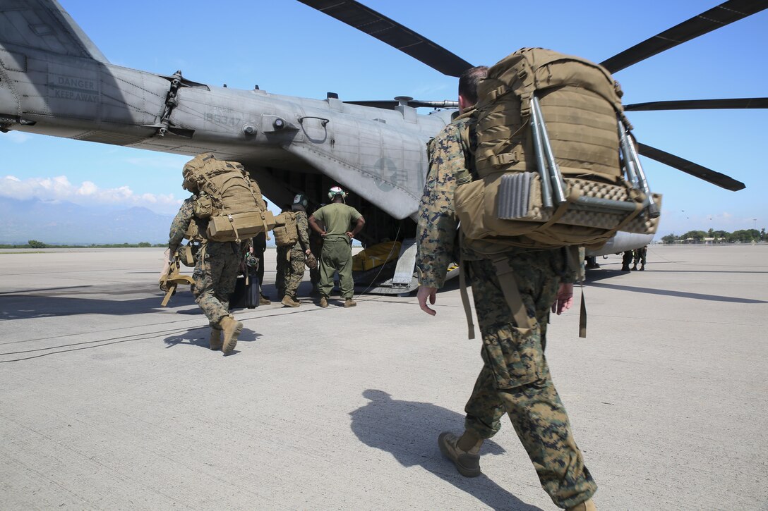 Marines with Special Purpose Marine Air-Ground Task Force Southern Command embark aboard CH-53E Super Stallion and depart to Grand Cayman Island at Soto Cano Air Base, Honduras 4 Oct. 2016. The SPMAGTF-SC is part of U.S southern Command response team staged at Cayman Island, ready to support U.S disaster relief operations in the Caribbean in response to Hurricane Matthew. SPMATF-SC deployed to Central America in June to serve as a rapid response force during the hurricane season. (United States Marine Corps photo by Sgt. Ian Ferro/Released)