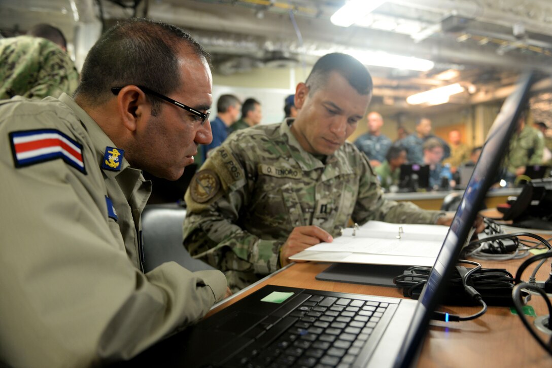 GULF OF PANAMA (Sept. 24, 2016) - Lt. Randall Mena, of Costa Rica, and Lt. j.g. Ovidio Tenorio, from the Republic of Panama, conduct operational planning during the UNITAS 2016 exercise portion on board USNS Spearhead (T-EPF 1). UNITAS is an annual multi-national exercise that focuses on strengthening our existing regional partnerships and encourages establishing new relationships through the exchange of maritime mission-focused knowledge and expertise throughout the exercise. (U.S. Navy Photo by Mass Communication Specialist 1st Class Jacob Sippel/RELEASED)