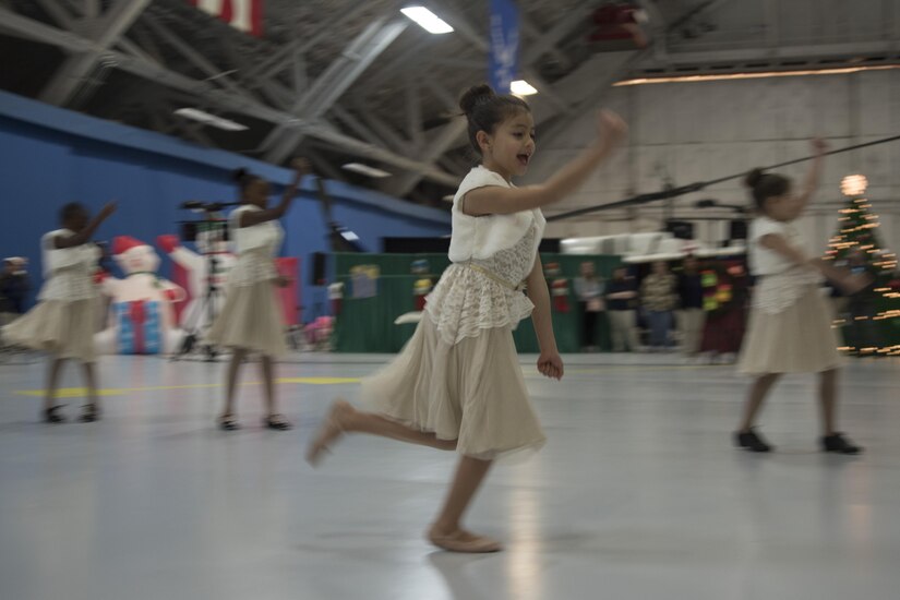 Agency 9 Performing Arts Studio dancers perform a dance to holiday music during the 2016 Parents and Children Fighting Cancer Christmas Party at Joint Base Andrews, Md., Dec.10, 2016.  Approximately 45 military families attended the event sponsored by the JBA Fisher House, where they were able to see performances by members of the U.S. Air Force Ceremonial Brass Band and community volunteers. (U.S. Air Force photo by Airman 1st Class Rustie Kramer)