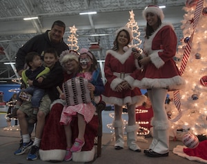 Mrs. Claus poses for a photo with attendees of the 2016 Parents and Children Fighting Cancer Christmas Party at Joint Base Andrews, Md., Dec. 10, 2016. Santa and Mrs. Claus delivered gifts to the military families in attendance. The JBA Fisher House has hosted the annual event since 1987.  (U.S. Air Force photo by Airman 1st Class Rustie Kramer)