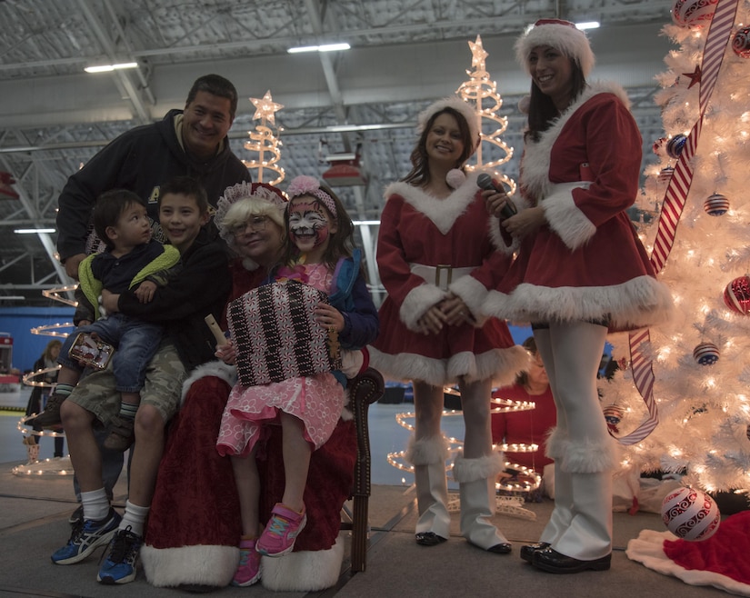 Mrs. Claus poses for a photo with attendees of the 2016 Parents and Children Fighting Cancer Christmas Party at Joint Base Andrews, Md., Dec. 10, 2016. Santa and Mrs. Claus delivered gifts to the military families in attendance. The JBA Fisher House has hosted the annual event since 1987.  (U.S. Air Force photo by Airman 1st Class Rustie Kramer)