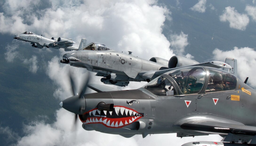 A Colombian Air Force A-29B Super Tucano flies alongside two U.S. Air Force A-10 Thunderbolt IIs from the 75th Fighter Squadron, Moody Air Force Base, Ga., during Exercise Green Flag East Aug. 21, 2016. Colombia and U.S. share a special relationship, and the joint training exercise provides a platform to strengthen those ties. Four Colombian A-29s and 45 Colombian Airmen are at Barksdale Air Force Base, La., through Aug. 29. (Photo courtesy Colombian Air Force)