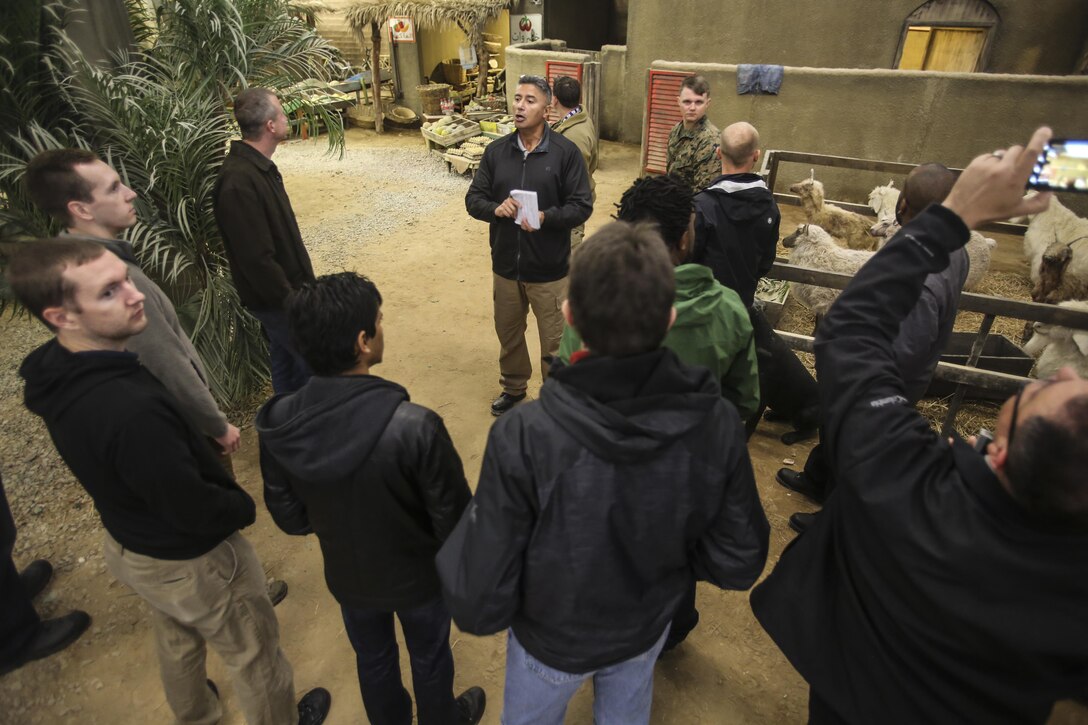 A contractor with the Infantry Immersion Trainer explains to members of the Office of Naval Research how the IIT helps Marines practice and train in real-life scenarios at Camp Lejeune, N.C., Dec. 7, 2016. The staff of the ONR took a tour of the base and various training facilities to give them a better idea of how their development, testing and evaluation translate to everyday training for the Marines. (U.S. Marine Corps photo by Lance Cpl. Miranda Faughn)