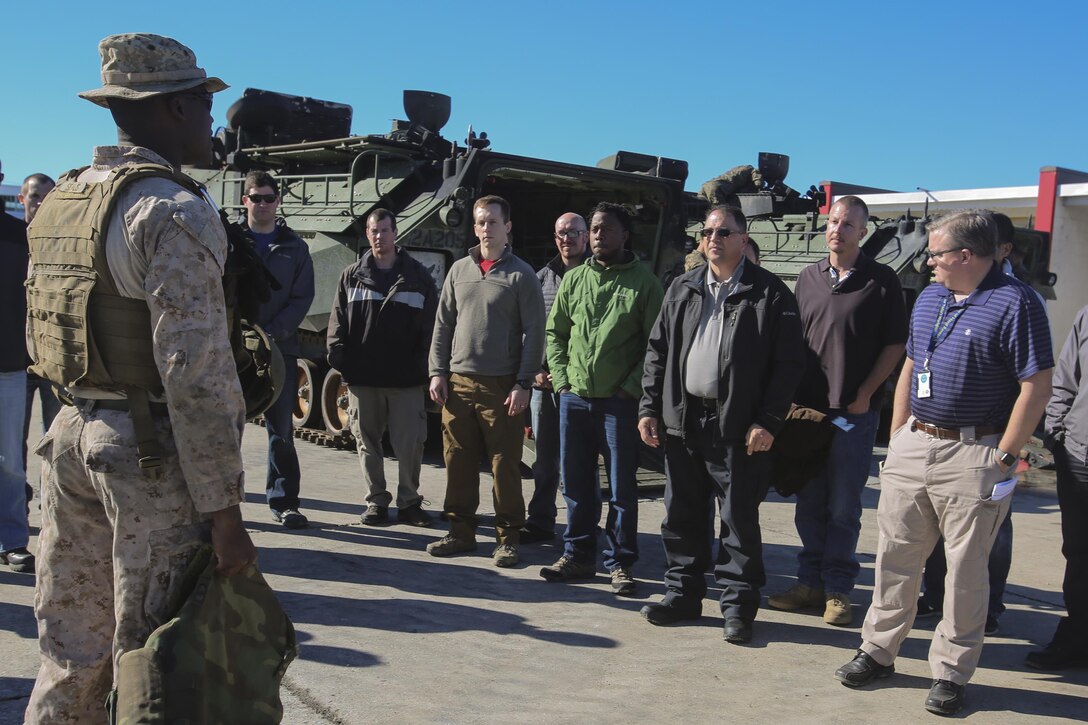 Marines brief members of the Office of Naval Research before receiving an amphibious assault vehicle familiarization ride at Camp Lejeune, N.C., Dec. 7, 2016.  Staff members of the ONR visited the base as part of the Scientist to Field Program for the research community to better understand the operational environment. The Marines are with 2nd Amphibian Assault Battalion. (U.S. Marines Corps photo by Lance Cpl. Miranda Faughn)