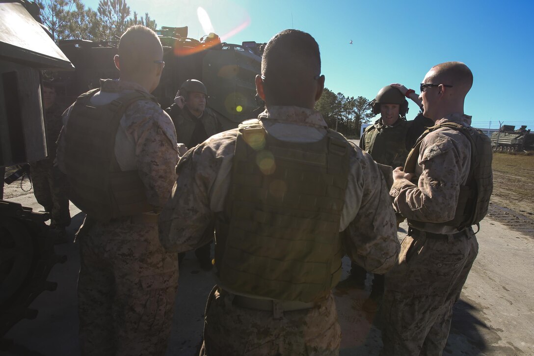 Marines brief members of the Office of Naval Research before receiving an amphibious assault vehicle familiarization ride at Camp Lejeune, N.C., Dec. 7, 2016.  Staff members of the ONR visited the base as part of the Scientist to Field Program for the research community to better understand the operational environment. The Marines are with 2nd Amphibian Assault Battalion. (U.S. Marines Corps photo by Lance Cpl. Miranda Faughn)