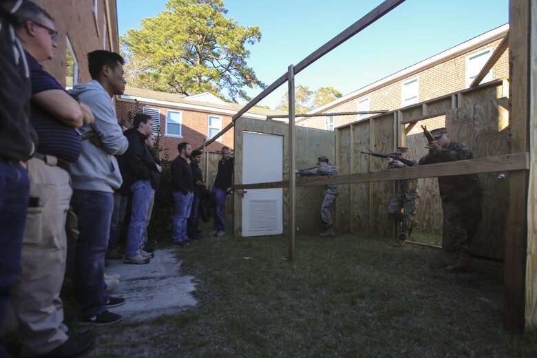 Marines demonstrate proper room-clearing techniques for members of the Office of Naval Research visiting Camp Lejeune, N.C., Dec. 7, 2016.  The staff of the ONR visited the base as part of the Scientist to Field Program for the research community to better understand the operational environment. The Marines are instructors with the Division Combat Skills Center. (U.S. Marines Corps photo by Lance Cpl. Miranda Faughn)