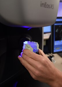 Senior Airman Jarryd Bigler, a dental laboratory apprentice course trainee, places a plaster model on a Computer-Aided Design and Computer-Aided Milling machine, or CAD/CAM, for scanning at the Medical Education and Training Campus on Joint Base San Antonio-Fort Sam Houston, Oct. 20, 2016.  The dental laboratory apprentice course curriculum is designed to teach basic skills such as fabricating full and partial dentures, crowns and veneers. (U.S. Air Force photo/Staff Sgt. Jerilyn Quintanilla) 