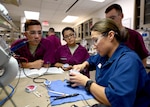Tech. Sgt. Elizabeth Blades, a dental laboratory apprentice course instructor, demonstrates a technique for carving out partial dentures at the Medical Education and Training Campus on Joint Base San Antonio-Fort Sam Houston, Oct. 20, 2016.  Blades is one of 10 Air Force instructors, all of whom are assigned to the 381st Training Squadron. (U.S. Air Force photo/Staff Sgt. Jerilyn Quintanilla)