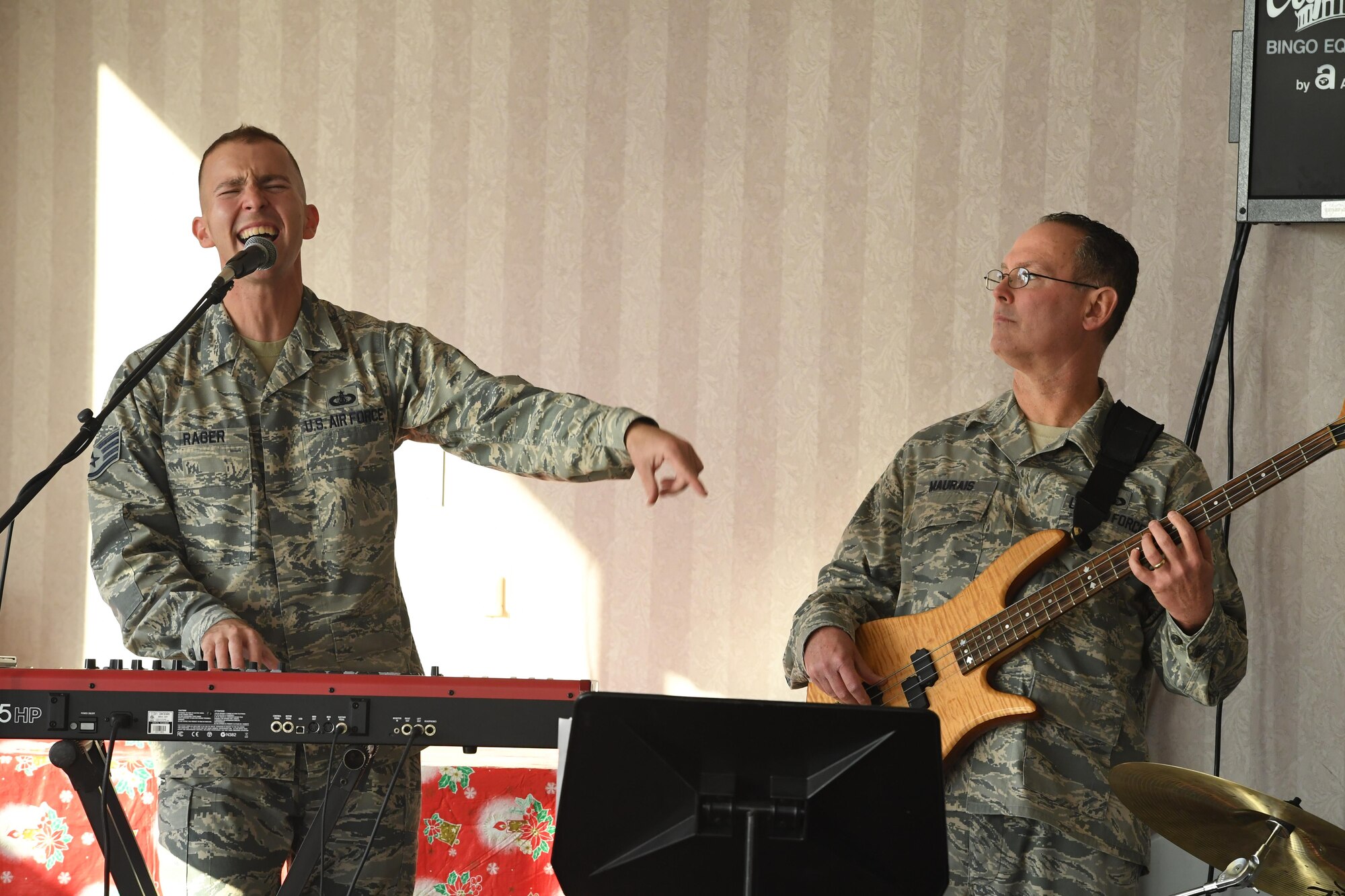 Staff Sgt. Ryan Rager, a keyboard player and vocalist with the U.S. Air Force Heritage of America Band, and Master Sgt. Kenny Maurais, a bassist with the United States Air Force Heritage of America Band, perform during a holiday concert at the Hampton Veteran’s Medical Center, Jan. 7, 2016. The Blue Aces are Airman-musicians who perform a diverse mix of American artists from the past and present. (U.S. Air Force photo by Staff Sgt. Nick Wilson)