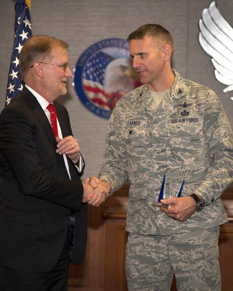 Col. Dave Learned, JSTARS Recap program manager, Battle Management Directorate, is congratulated by Steve Wert, Battle Management program executive officer, and Susan Angell, Acquisition Excellence and Program Execution Directorate Operating Location Hanscom site senior functional, after being named winner in the Outstanding Program Management Acquisition Category I, military, during the fourth annual Air Force Life Cycle Management Center Acquisition Management Awards Dec. 13. The awards recognize individuals and teams who demonstrated excellence in managing acquisition and test programs. (U.S. Air Force Photo by Mark Herlihy) 