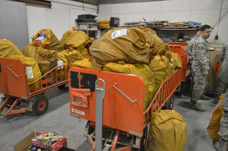THULE AIR BASE, Greenland—Operation Julemand volunteers at Thule Air Base, Greenland, load carts with gifts Dec. 6, 2016, to be transported by helicopter or dogsled to local villages. Every year, personnel from the 821st Air Base Group, a geographically separated unit of the 21st Space Wing at Peterson Air Force Base, Colo., gather goods at Thule AB to be given to children at Christmas parties in the local villages as part of Operation Julemand. (Courtesy photo)