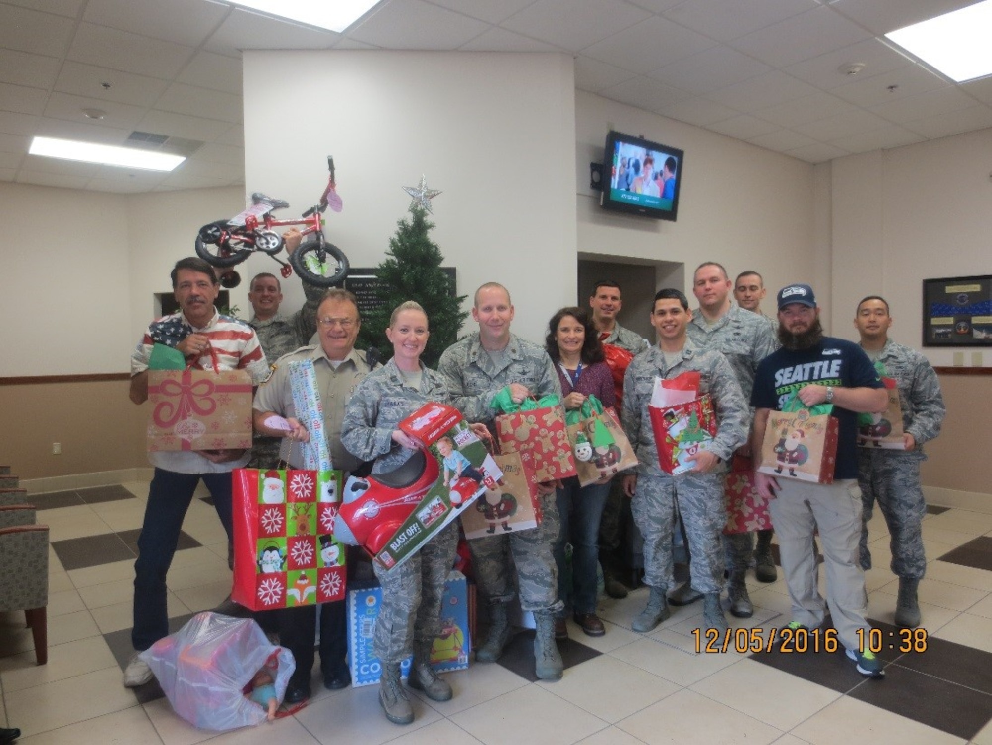 EGLIN AIR FORCE BASE, Fla.—Members from the 20th Space Control Squadron at Eglin Air Force Base, Fla., show off some gifts obtained for local children Dec. 5, 2016. Each year the squadron, a geographically separated unit of the 21st Space Wing at Peterson AFB, Colo., takes part in the installation’s Angel Tree program, which gives underprivileged kids toys and clothes during the holidays. (Courtesy photo)