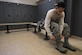 Senior Airman Anthony Vallejos, 811th Security Forces Squadon raven, ties his boots inside the newly renovated West Fitness Center locker room at Joint Base Andrews, Md., Dec. 13, 2016. The improvements to the locker rooms included new ceilings, saunas, lockers, and heating ventilation and air conditioning units. (U.S. Air Force photo by Senior Airman Philip Bryant)