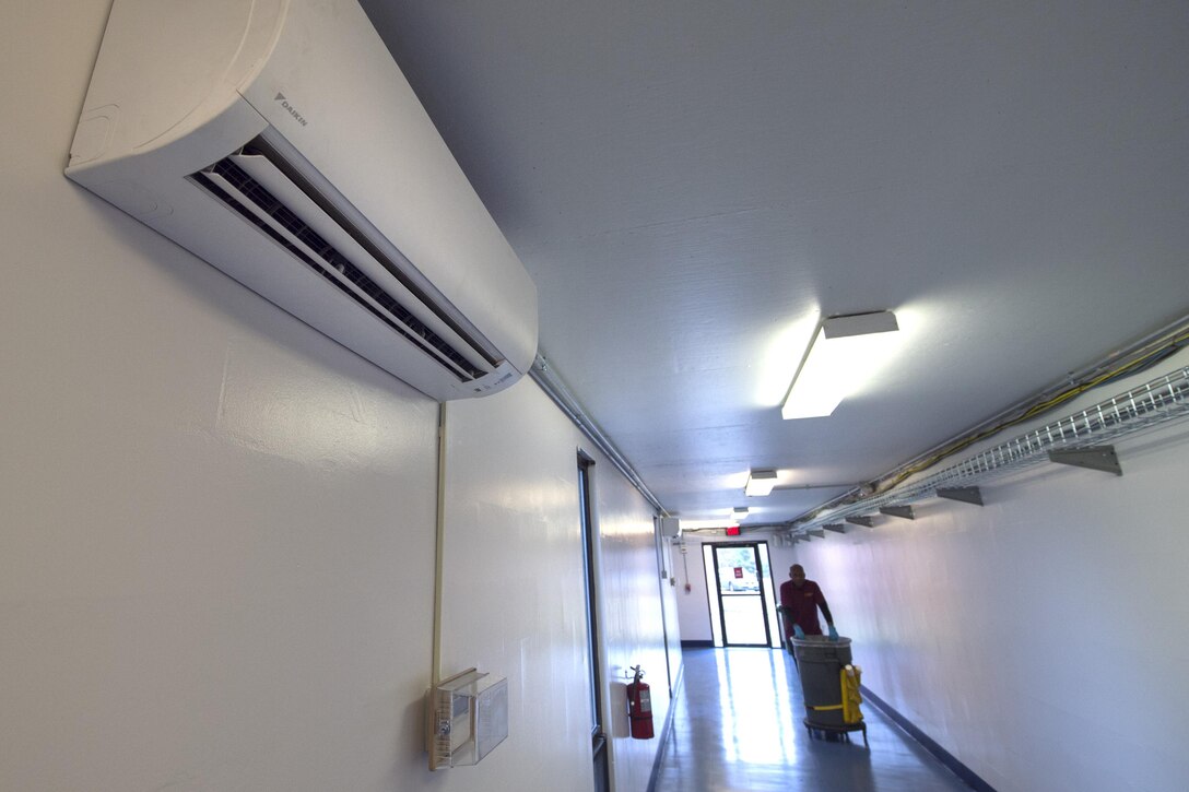 A custodian walks through the newly renovated halls in the West Fitness Center at Joint Base Andrews, Md., Dec. 13, 2016. The renovation included new floors, new paint, and heating ventilation and air conditioning units that keep the temperature in the halls between the main gym and tactical area controlled. (U.S. Air Force photo by Senior Airman Philip Bryant)