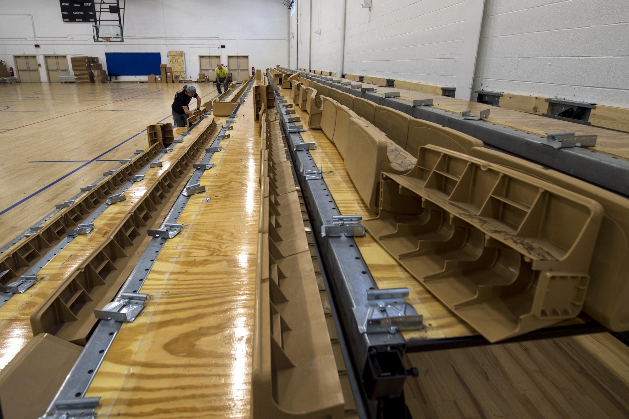 Construction workers renovate the basketball raisers in the West Fitness Center at Joint Base Andrews, Md., Dec. 13, 2016. The renovation of the fitness center is scheduled to commence in February 2017. (U.S. Air Force photo by Senior Airman Philip Bryant)