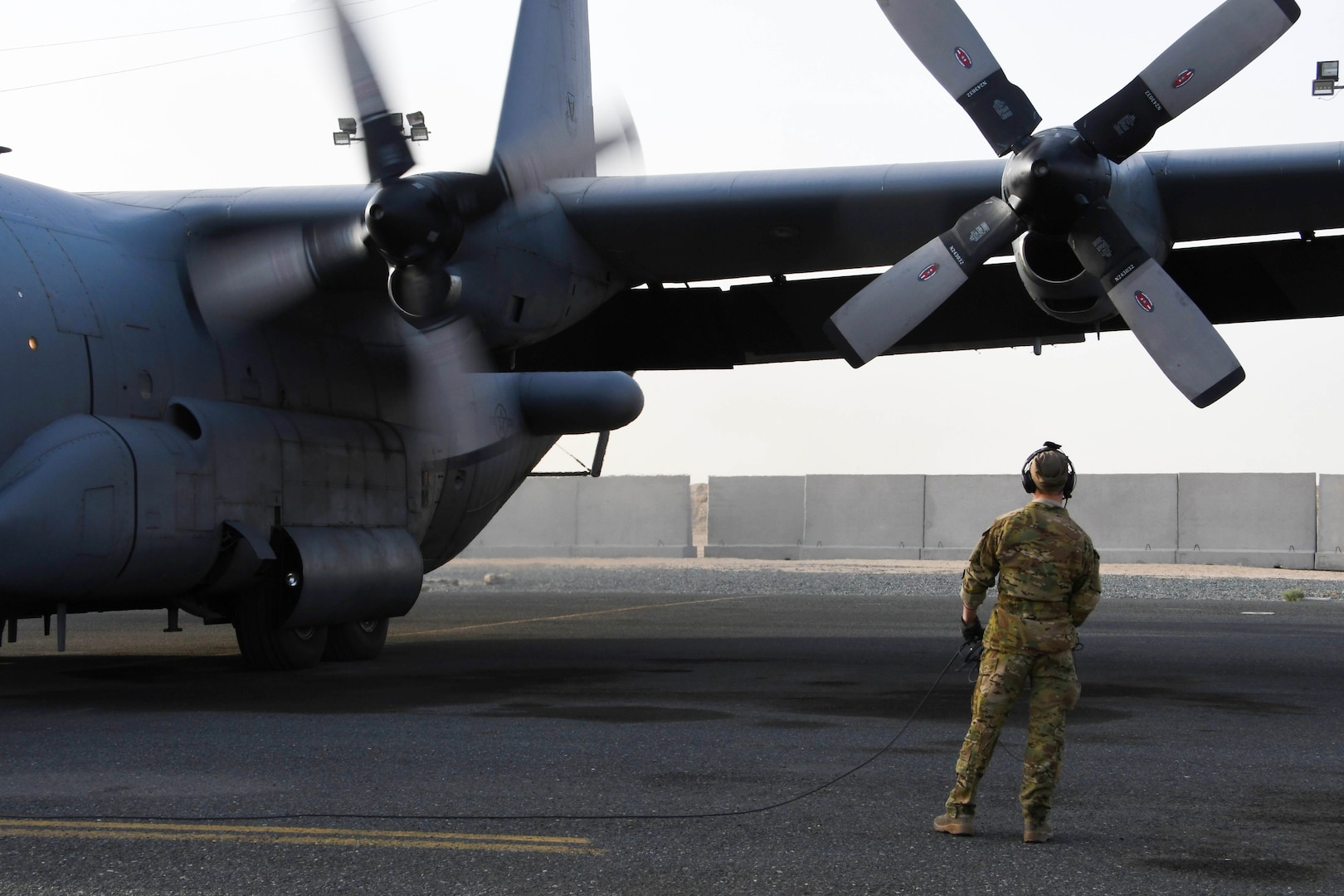 A 386th Expeditionary Operations Group airborne maintenance technician monitors an EC-130H Compass Call as it starts its engines on Dec. 5, 2016 at an undisclosed location in Southwest Asia. The Compass Call is engaged in operations jamming Da’esh communications in order to confuse and disorient enemy fighters. (U.S. Air Force photo by Senior Airman Andrew Park)