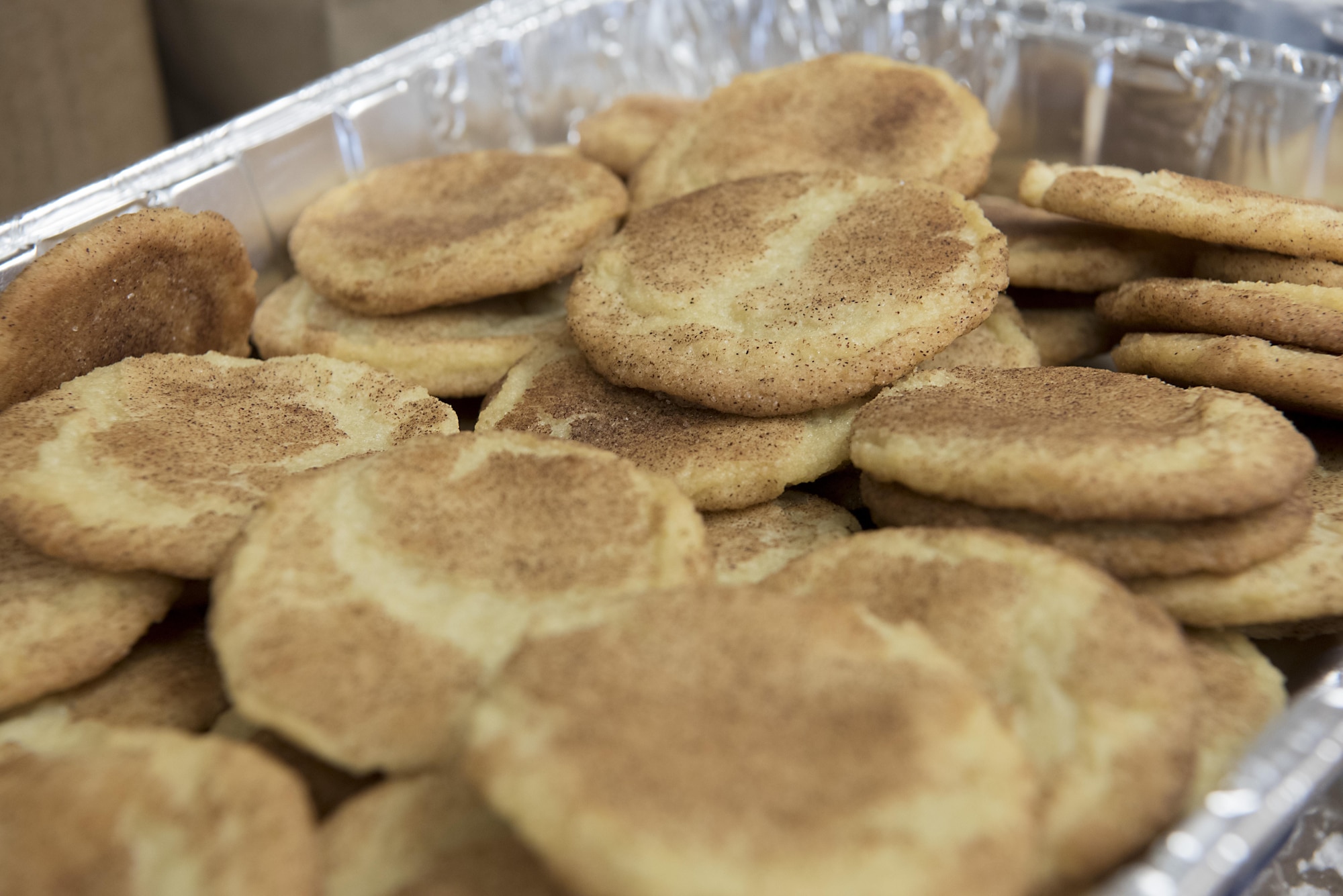PETERSON AIR FORCE BASE, Colo. – The 21st Space Wing key spouses and Diamond Council collect cookies and baked goods at the Peterson Chapel at Peterson Air Force Base, Colo., Dec. 8, 2016. Every year the key spouses collect and package them and the Diamond Council distributes the cookies to the Airmen living in the dorms and 24-hour facilities to give them a little taste of home for the holidays. (U.S. Air Force photo by Steve Kotecki)
