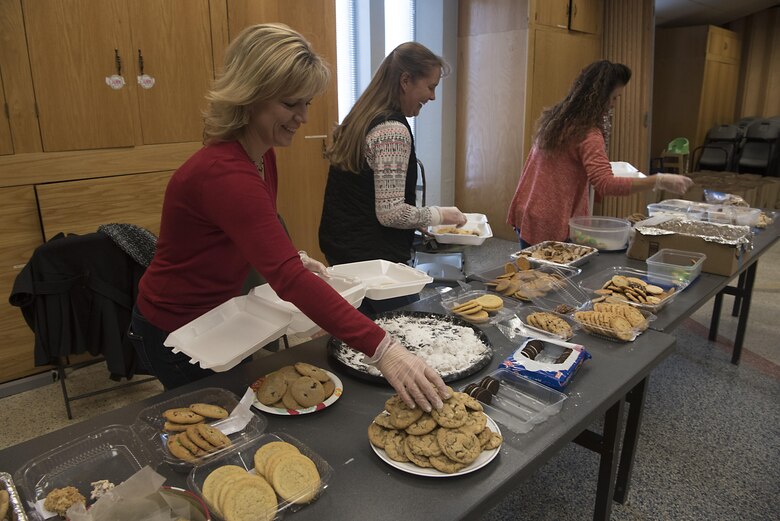 PETERSON AIR FORCE BASE, Colo. - Debbie Schiess, Crystal Bracy and Jennifer Dorminey, 21st Space Wing key spouses, package cookies for the Airmen of Team Pete at the Peterson Chapel at Peterson Air Force Base, Colo., Dec. 8, 2016. Every year key spouses collect and package cookies and the Diamond Council distributes the them to the Airmen living in the dorms and 24-hour facilities to give them a little taste of home for the holidays. (U.S. Air Force photo by Steve Kotecki)