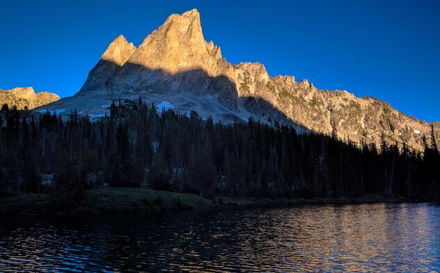 The last remaining daylight slips off El Capitan Mountain above Alice Lake, Idaho, July 16th, 2016. Alice Lake is one of several alpine lakes chained beneath the mountain. (U.S. Air Force photo by Senior Airman Connor J. Marth/Released)