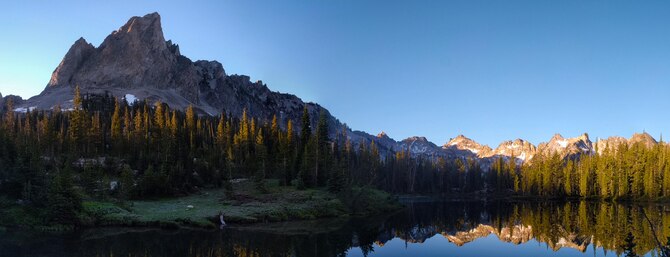 The El Capitan mountain range reflects off the still waters of Alice Lake in the Sawtooth National Forest, Idaho, July 16th, 2016. Alice Lake is one of several alpine lakes chained beneath the mountain. (U.S. Air Force photo by Senior Airman Connor J. Marth/Released)