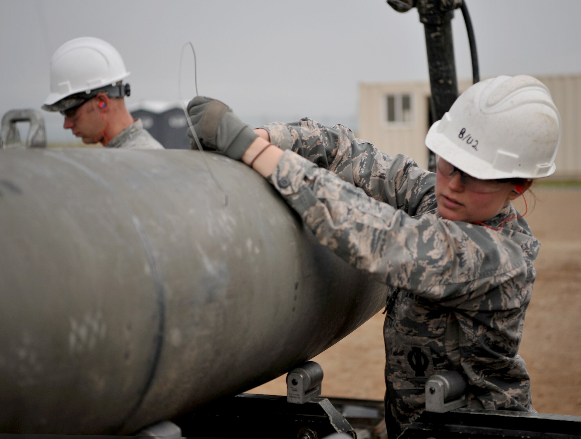 Airmen work together to build a munition at the munitions pad Dec. 13, 2016, at Beale Air Force Base, California. The Airmen are currently in a munitions career field upgrade training course at the Air Force Combat Ammunition Center. (U.S. Air Force photo/Staff Sgt. Jeffrey Schultze)