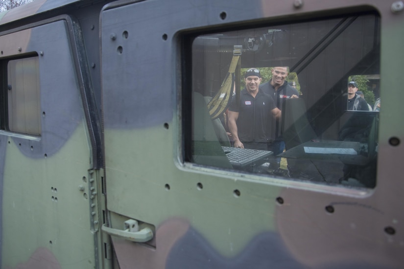 Chad Gable and Jason Jordan, World Wrestling Entertainment Superstars, view the inside of a Humvee at Joint Base Andrews, Md., Dec. 13, 2016. The 11th Security Support Squadron was the Superstars’ first stop in a tour of JBA, during which they viewed and interacted with the security forces MWD section, combat gear, weapons systems and other aspects of the unit. Also during their visit to JBA, they flew in UH-1N Iroquois helicopters and participated in a signing event at the Base Exchange. (U.S. Air Force photo by Senior Airman Jordyn Fetter)