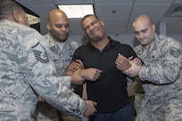 Jason Jordan, World Wrestling Entertainment Superstar, participated in a taser demonstration conducted by 11th Security Support Squadron members at Joint Base Andrews, Md., Dec. 13, 2016. In addition to experiencing security forces training requirements like tasing, the Superstars viewed combat gear, weapons systems and other aspects of the unit. The group visited JBA to see and broadcast the missions of Airmen here and gain a more comprehensive understanding of the roles of the service members. (U.S. Air Force photo by Senior Airman Jordyn Fetter)