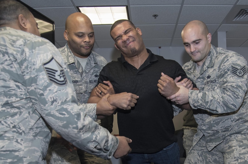 Jason Jordan, World Wrestling Entertainment Superstar, participated in a taser demonstration conducted by 11th Security Support Squadron members at Joint Base Andrews, Md., Dec. 13, 2016. In addition to experiencing security forces training requirements like tasing, the Superstars viewed combat gear, weapons systems and other aspects of the unit. The group visited JBA to see and broadcast the missions of Airmen here and gain a more comprehensive understanding of the roles of the service members. (U.S. Air Force photo by Senior Airman Jordyn Fetter)