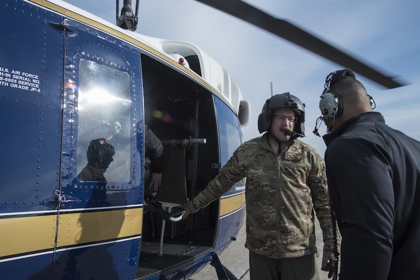 Tech. Sgt. Matt Dunn, 1st Helicopter Squadron flight engineer, directs Jason Jordan, World Wrestling Entertainment Superstar, into a UH-1N Iroquois at Joint Base Andrews, Md., Dec. 13, 2016. The squadron provided a rare tour of the National Capital Region aboard their aircraft for the Superstars, showing them national monuments like the Washington Monument, U.S. Capitol Building and Martin Luther King, Jr. Memorial. The Superstars visited JBA as a way to show their appreciation for the sacrifices military members have made, give back to the community and understand some of the missions that make up the armed forces. (U.S. Air Force photo by Senior Airman Jordyn Fetter)