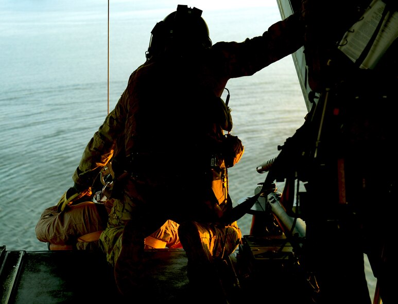 A special mission aviator at the 8th Special Operations Squadron assists two special operators onto a CV-22 Osprey near Hurlburt Field, Fla., Dec. 12, 2016. Gen. Ellen M. Pawlikowski, commander of Air Force Materiel Command, was onboard the aircraft to observe the water-hoist demonstration. (U.S. Air Force photo/Staff Sgt. Melanie Holochwost)