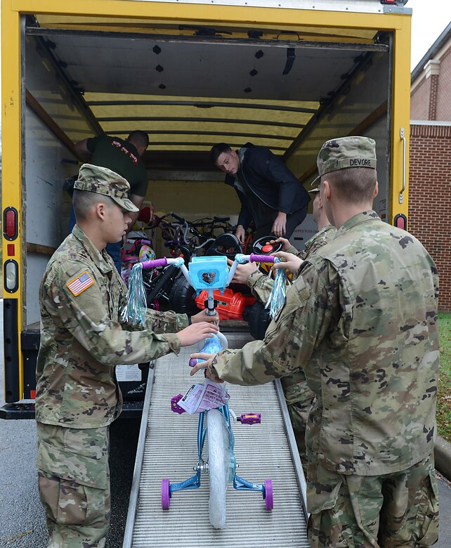 U.S. Army Soldiers assigned to 1st Battalion, 222nd Aviation Regiment, assist U.S. Marines as they load donated toys into trucks at Joint Base Langley-Eustis, Va., Dec. 8, 2016. Some of the toys donated included bicycles, video games and other toys for all age groups. (U.S. Air Force photo by Staff Sgt. Teresa J. Cleveland)