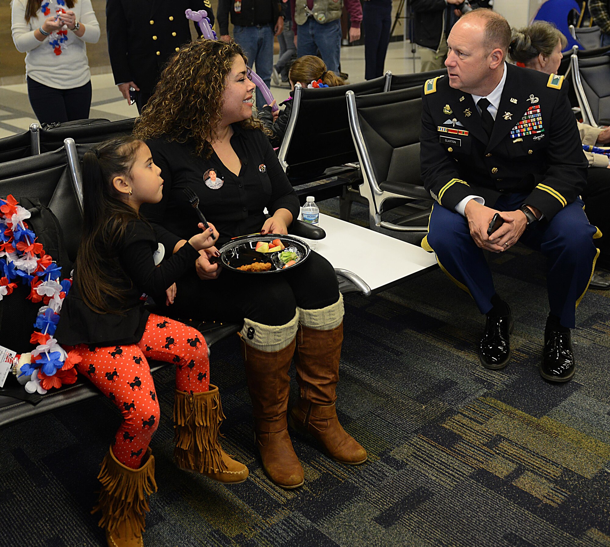 Adriana Quintana, age 5, and her mother Nilda Quintana, Gold Star family members from Hampton Roads, Va., speak with U.S. Army Col. Ralph Clayton III, 733rd Mission Support Group commander, during the Snowball Express at Norfolk International Airport, Va., Dec. 11, 2016. Nilda’s husband, Daniel Quintana, passed away while on active duty in 2011, just three months before Adriana was born. (U.S. Air Force photo by Staff Sgt. Teresa J. Cleveland)