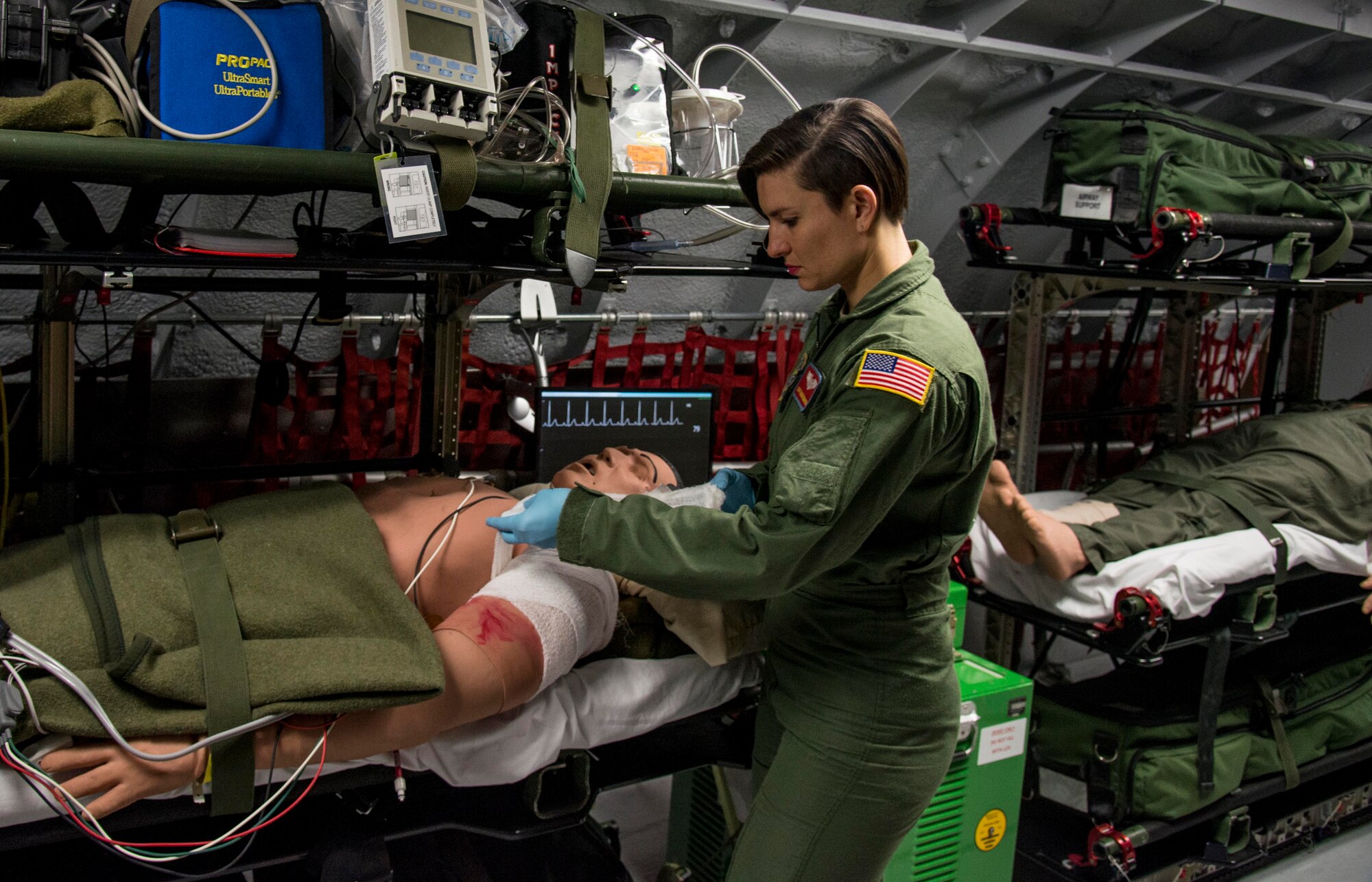 Staff Sgts. Dasha Ermanova conducts medical training aboard the new KC-135 static trainer on Scott Air Force Base, Ill., May 5, 2016. Aeromedical evacuation technicians are required to participate in the simulator two times every six months. (U.S. Air Force photo by Airman 1st Class Daniel Garcia)