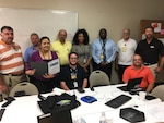 Eleven Defense Contract Management Agency Orlando employees attended a one-day workshop, Product Quality Deficiency Report Workshop, which focused on detection to prevention and other surveillance methods, Sept. 14. Front row: Nadia Aponte, Gregory Abramowitz and Jose Melendez. Back row: Les Jones, Major Yarborough, Paul Giannetti, Carisse Zorrilla-Medina, Tommy Moody, Paul Harrison, and Odin Keller. Absent from photo is Lance Woods and Count Kately. (Photo courtesy of DCMA Orlando)