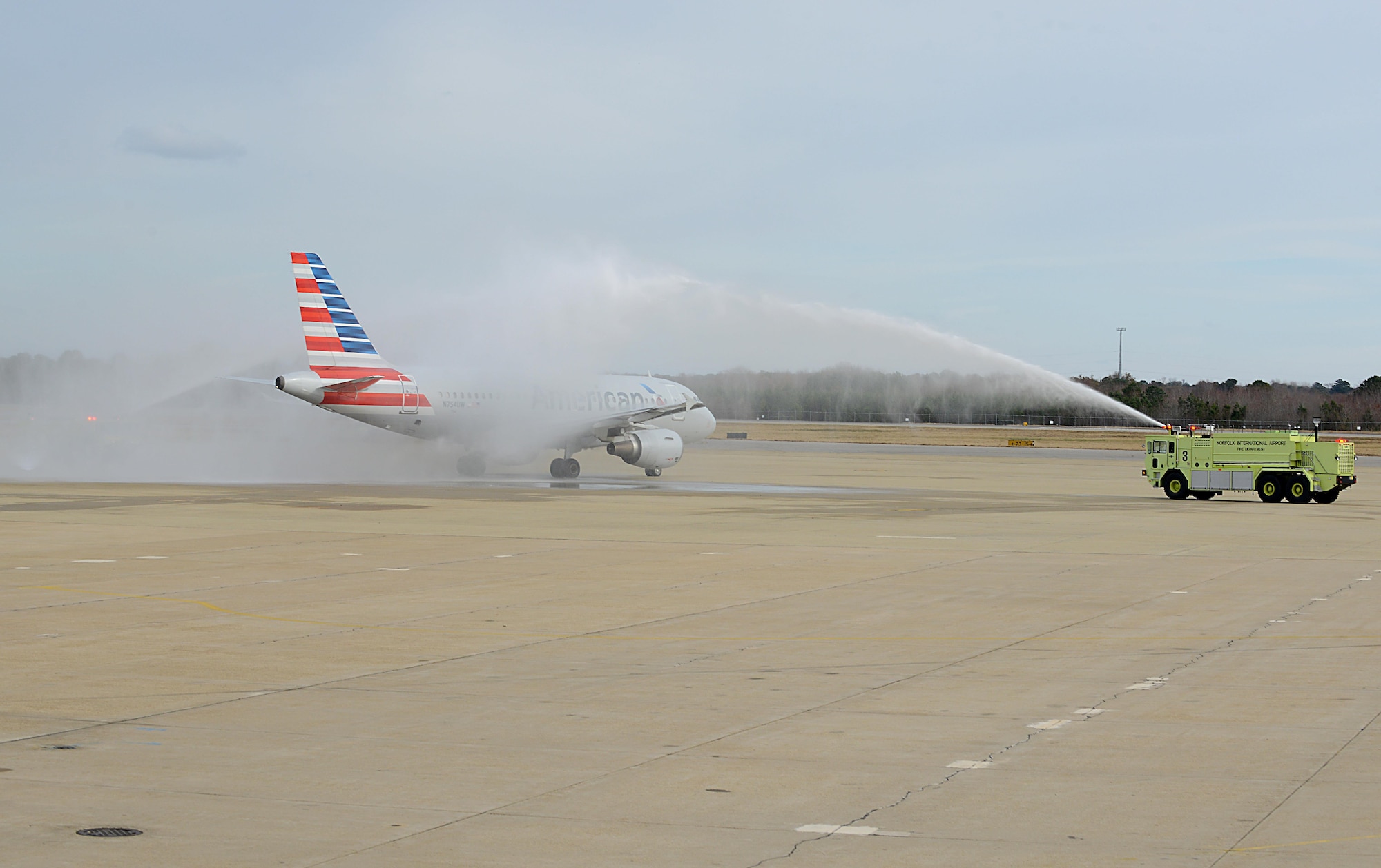 The Snowball Express flight from American Airlines taxis through streams of water at Norfolk International Airport, Va., Dec. 11, 2016. Gold Star families from around the world came together to see a performance by Gary Sinise and the Lt. Dan Band, a ceremonial balloon release and many other surprise activities over the four-day, all-expenses paid trip.(U.S. Air Force photo by Staff Sgt. Teresa J. Cleveland)