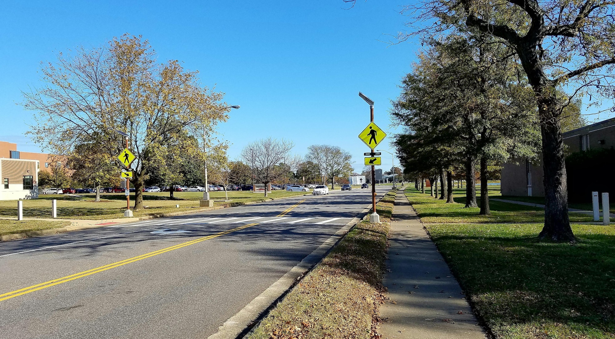 The lighted pedestrian crosswalk on Nealy Avenue, between the U.S. Air Force Hospital Langley and 633rd Medical Group Dental Clinic, was installed due to high volume vehicle and pedestrian traffic at Joint Base Langley-Eustis, Va., in 2016. As pedestrians approach the street, motion sensors activate flashing lights to alert drivers to slow down and stop for pedestrians using the crosswalk. (U. S. Air Force photo by Beverly Joyner)