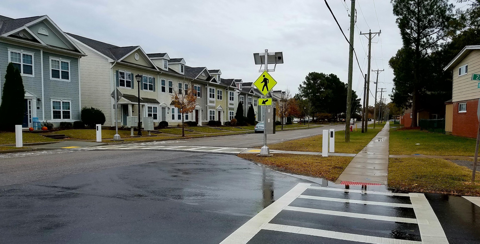 The 733rd Civil Engineer Division installed a lighted pedestrian crosswalk at 26th Street and Madison Avenue, near a school bus stop at Joint Base Langley-Eustis, Va., Nov. 14, 2016. The 733rd CED coordinated with the Fort Eustis Residential Working Group to address pedestrian safety issues at this location. As pedestrians approach the street, motion sensors activate lights across the road to alert drivers to slow down and stop for pedestrians using the crosswalk. (U. S. Air Force photo by Beverly Joyner)
