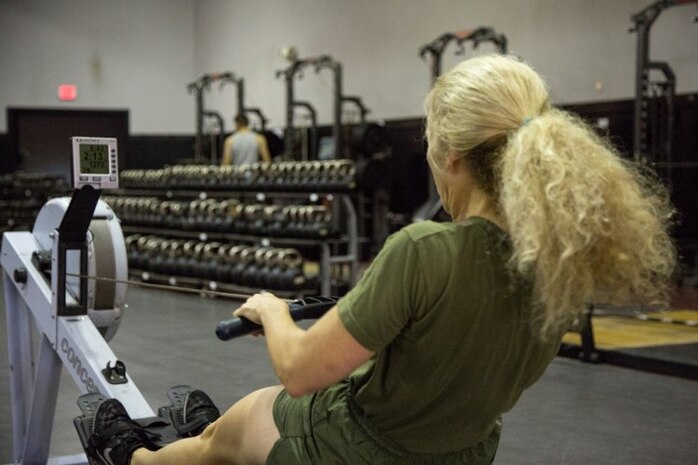 Female Marine demonstrating proper rowing technique