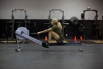 Female Marine demonstrating proper rowing technique
