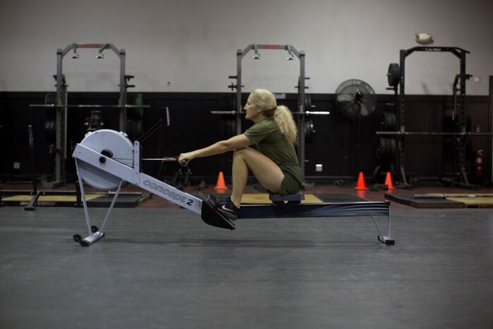 Female Marine demonstrating proper rowing technique