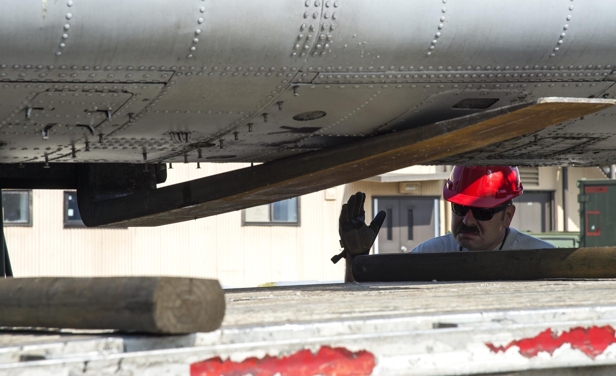 Tech. Sgt. Thomas Breining, 23d Equipment Maintenance Squadron repair and reclamation NCO in charge directs a forklift lowering the fuselage of an A-10A Thunderbolt II onto a flatbed truck, Dec. 1, 2016, at Moody Air Force Base, Ga. A lot of A-10As received upgrades in technology that converted them to A-10Cs, but few remained as static displays, training aircraft and spare parts for the upgraded aircraft. (U.S. Air Force photo by Staff Sgt. Eric Summers)